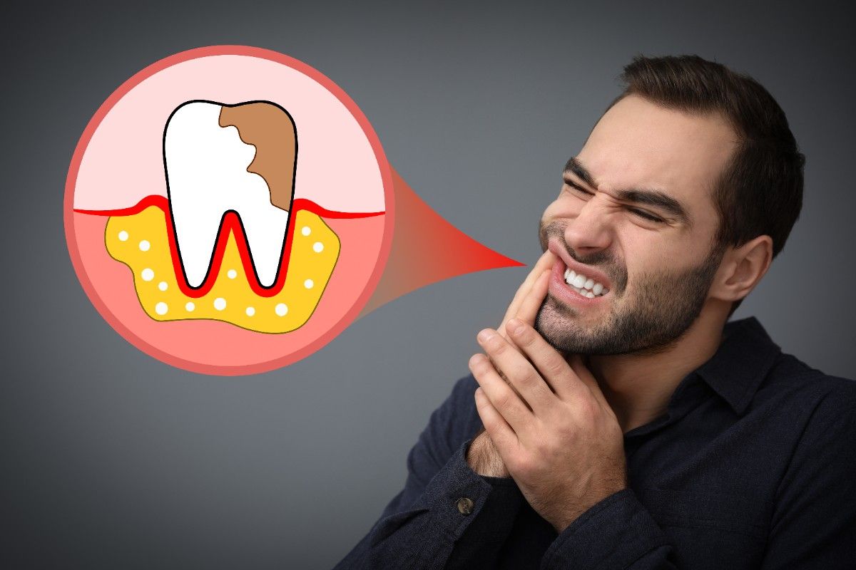 young-man-suffering-from-toothache-grey-background (1)